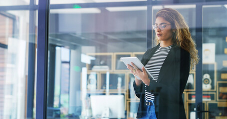 Poster - Creative woman, browsing and research with tablet by window for company or project design at office. Female person, designer or employee with technology for schedule, planning or tasks at workplace