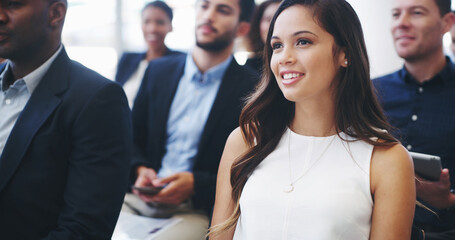 Poster - Business woman, happy and listening in audience for budget speech, finance and seminar for growth in economy. Person, smile and crowd at conference, attention and auditorium for corporate convention