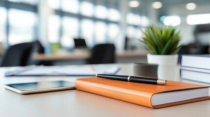 Poster - Modern Office Workspace with Notebook, Pen, Tablet, and Green Plant in Soft Focus Environment, Ideal for Business and Creative Projects