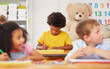 © peopleimages.com - Preschool, students and child with writing for education, cognitive development and test knowledge. Classroom, kids and boy with drawing for creative art, learning and academic activity for learner
