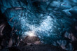 © Erika Valkovicova - Naturally formed blue ice cave with bubbles in Vatnajokull glacier national park