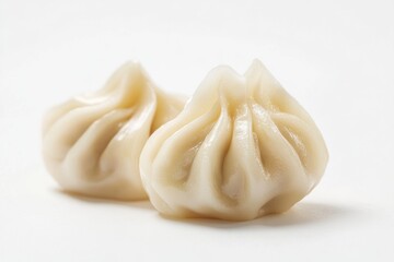 Aufkleber - A pair of dumplings sitting on a white surface, often used as a prop or decoration in photography and food styling