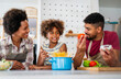 © NDABCREATIVITY - Overjoyed young african american family with kid have fun cooking at home together,