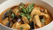 © Timeless Touch - Delicious chicken and eggplant dish with fresh basil and tomato sauce in a white bowl