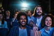 © Marko Geber - Group of friends watching movie at cinema enjoying popcorn
