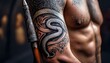 © Photo by mQ - A close-up of a tribal tattoo on a warrior’s arm, showcasing a snake motif wrapped around, symbolizing strength, rebirth, and wisdom.