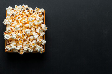 A wide-lens perspective: the clapper and popcorn arranged side by side at the center of an