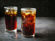 © NARONG - Cola soft drink with ice cubes, soda fizzy drink in Cold two glass on gray background