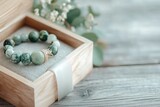 A jade bracelet presented in a luxurious gift box lined with velvet, with a ribbon tied elegantly around it