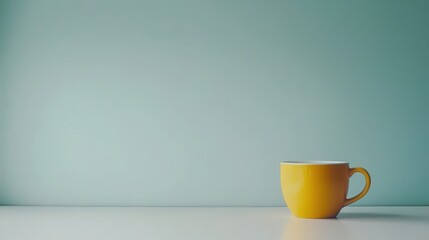 Poster - Bright yellow mug placed on a clean white table setting with soft natural light illuminating it