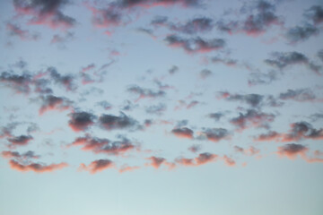 Wall Mural - A beautiful sky tinted by the sun leaving vibrant shades of gold, pink, blue and multicolored. Clouds in the twilight evening and morning sky. Cloudy sky background in the evening, and during the day.