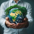 © fotofabrika - Person holds a globe covered with greenery symbolizing environmental protection and sustainability efforts worldwide