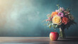 © Erika - un ramo de flores colorido junto a una manzana roja sobre una mesa de madera y una pizarra verde en un salon de clases celebrando el dia del maestro en la escuela