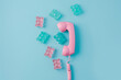 © apimagine - A telephone handset surrounded by colorful gummy candies, creating a playful and vibrant composition.