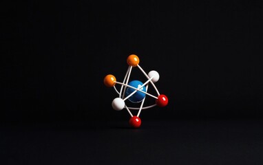 Aufkleber - 3D Model of a Molecule with a Blue Nucleus and Colorful Atoms Connected by White Bonds Against a Dark Background