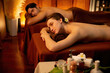 © InfiniteFlow - Caucasian couple customer enjoying relaxing anti-stress spa massage and pampering with beauty skin recreation leisure in warm candle lighting ambient salon spa at luxury resort or hotel. Quiescent