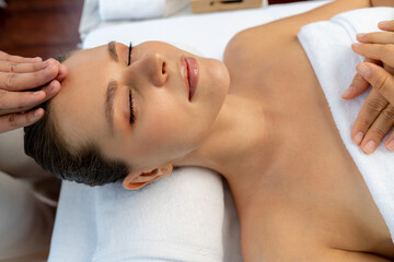 caucasian woman enjoying relaxing anti-stress head massage and pampering facial beauty skin recreati