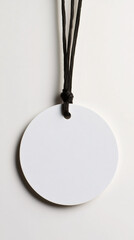 Poster - White circular tag dangling from dark cord against pristine surface, perfect for branding customization