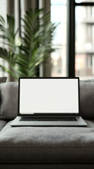 Poster - Modern laptop with blank screen standing on comfortable sofa in stylish living room, mockup for website design or application presentation