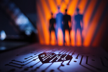 Poster - Silhouetted Figures Against an Orange Background with Heart-Shaped Circuit Design in the Foreground