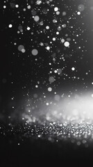 Poster - Silver glitter falling on a black background creating a magical bokeh effect, perfect for luxury, festive, or glamorous designs