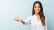 © Vivid_Vision - Smiling woman in white shirt extending hand in welcoming gesture