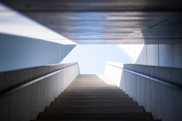 Poster - Modern Architectural Staircase Leading Upward into a Bright Sky