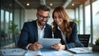 © EnioRBC - Collaborative Business Success Happy Male and Female Executives Working Together as Partners, Reviewing Financial Data on a Digital Tablet in a Corporate Office Environment.
