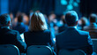 © Mix Creative - An international conference in the USA is being attended by a group of business people sitting on chairs on stage and conversing with one another.
