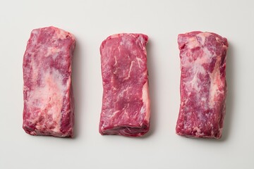 Poster - Three thick slices of raw beef steak arranged side by side on a clean white surface for culinary inspiration : Generative AI
