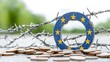 © RAKSIWAH - EU Flag Circle Entangled in Barbed Wire with Coins Economic Crisis Concept
