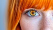 © iyo - Close-up of a woman's hazel eye with freckles and vibrant orange hair.