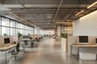 © malayeka - Modern open-plan office with workstations, natural light, and exposed pipes.
