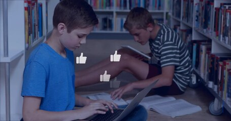 Poster - In school library, two boys studying with animation of thumbs-up icons floating