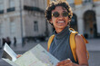 © bernardbodo - Tourist smiling and reading a map in lisbon, portugal