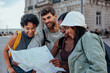 © bernardbodo - Happy tourists consulting a map in city center