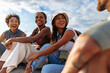© bernardbodo - Tourists laughing together on a sunny day during vacation