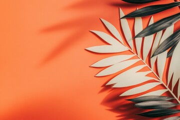 Poster - Colorful arrangement of palm leaves casting shadows on a vibrant orange background in a bright indoor setting