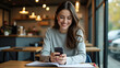 © Netaya - Modern Work Lifestyle: Woman Happily Working with Smartphone and Notebook in Coffee Shop - Remote Working Concept with Empty Space for Your Ideas