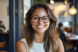 © kristina - Woman with glasses smiling at camera.