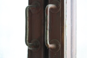 Poster - A close-up view of a wooden door handle, often used in architectural or interior design images.