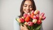 © Chainarong - Joyful Young Woman Embracing Tulips in Studio Setting, Capturing Happiness and Love