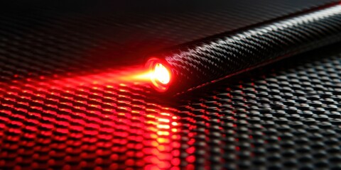 Poster - A red light is glowing on a black surface