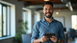 © HaJung - Smiling Latin Male Project Manager in Office: Happy Young Professional Using Tablet - Stock Photo Concept with Empty Space for Your Design Needs