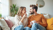 © Radorog. - A couple in love on the couch drinking coffee