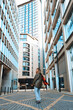 © Iryna - Stunning cityscape featuring a young person enjoying urban life in a modern architectural setting during daylight