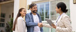 © fizkes - Happy family couple and real estate agent woman shaking hands, finding accommodations for rent, house for buying, closing deal, successful apartment hunting, getting mortgage approval. Banner shot