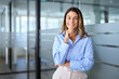 Happy middle aged business woman attorney, smiling 45 years old lady entrepreneur, mature female professional executive, bank manager, corporate leader standing in office looking at camera, portrait.