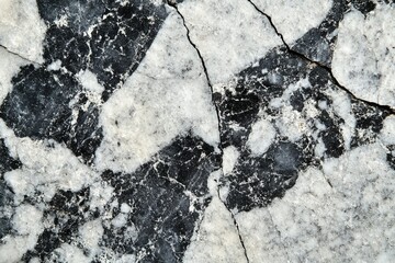 Aufkleber - Black and white marble stone with cracks, showing intricate patterns and textures.
