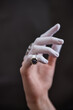 © Seventyfour - Close-up of an elegant hand adorned with a sapphire ring and delicate white glove highlighting the wearer's sophisticated style